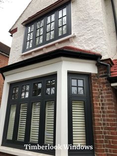 a white house with black windows and shutters