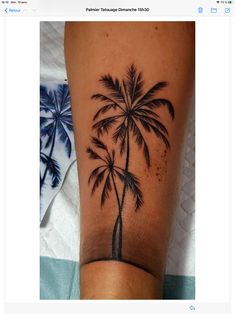 a small palm tree tattoo on the leg