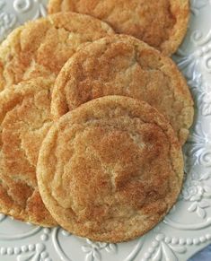 four cookies on a white plate sitting on a table