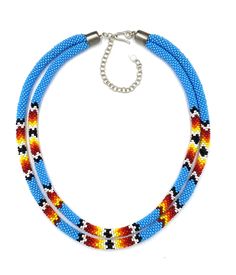 a multi colored beaded necklace on a white background