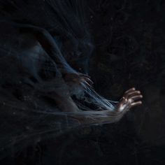 a woman with her hands out in the dark