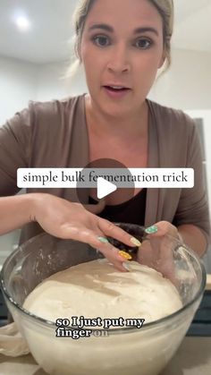 a woman is mixing some food in a bowl