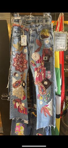 a pair of jeans with patches and flowers on them