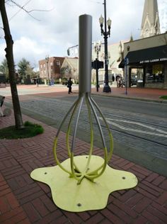 a metal object sitting on top of a sidewalk