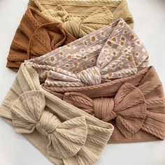 four different types of headbands with bows on top of each one in various colors