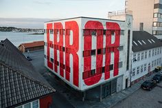 a large building with the word stop painted on it's side in red and white