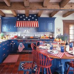 a kitchen with blue cabinets and an american flag hanging from the ceiling