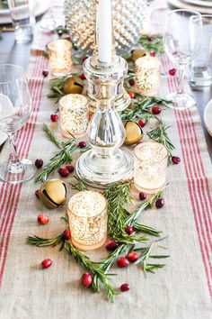 the table is set with candles, crackers and other holiday decorations on top of it