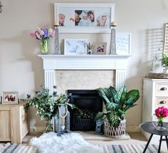 a living room filled with lots of furniture and flowers on top of a fire place