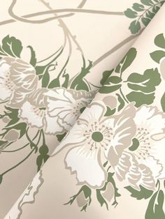 a white and green wallpaper with flowers on it