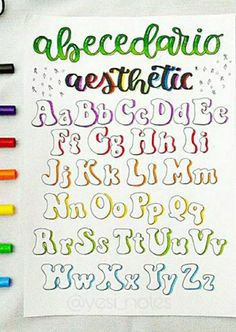 the alphabet and numbers are drawn with crayons on paper, which is laid out next to each other