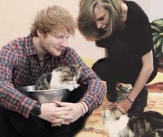 a man holding a bowl with a cat in it next to a woman on the floor