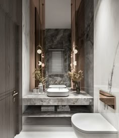 a modern bathroom with marble counter tops and wooden cabinets, along with a white toilet