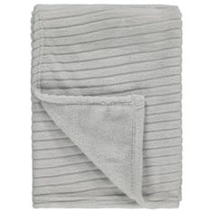 the grey blanket is folded on top of it's white backing and has a pocket for