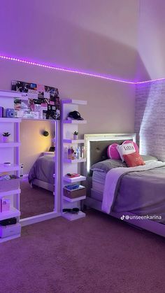 a bed room with a neatly made bed and purple lights on the ceiling above it