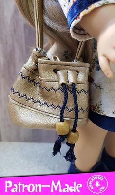 the doll is holding a purse on her hand