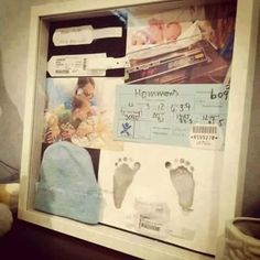 a baby's hand and foot prints are displayed in a shadow box on the wall