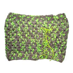 a green and gray crochet purse with yellow string