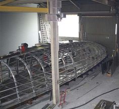 a large metal boat being built in a building