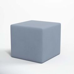 a blue cube sitting on top of a white floor