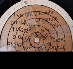 a close up of a wooden disc with writing on it