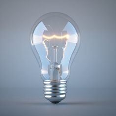 an illuminated light bulb on a gray background