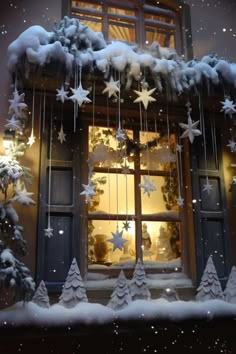 a window decorated with snow and christmas decorations