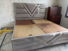 a bed that has been made and is in the process of being built with plywood