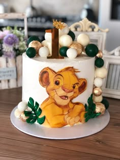 a lion themed birthday cake on a table