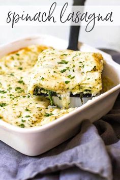 a casserole dish with broccoli and cheese in it on a blue towel