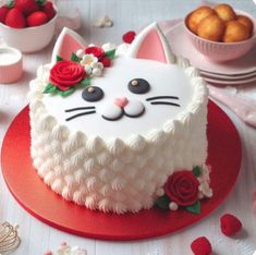 a cake with white frosting and red flowers on it