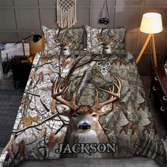 a bed with deer head on it and name jackson printed on the comforter cover