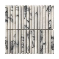 white marble tiles are arranged in the shape of vertical bars, with black and white veining