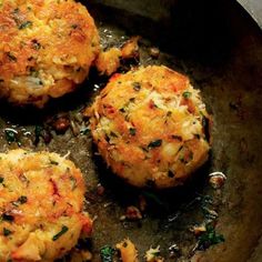 three crab cakes sitting on top of a pan