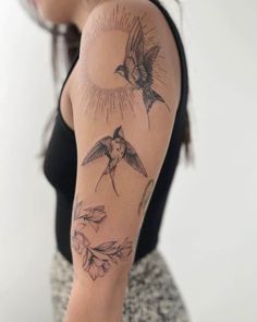 a woman with a bird tattoo on her arm