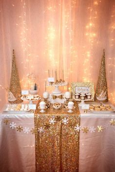 a table topped with gold and white desserts