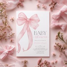 a baby shower is shown with pink flowers and ribbon on it's back side