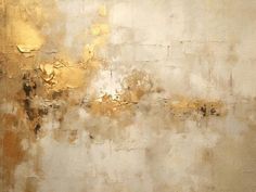 an abstract painting with gold and white paint on the wall, it appears to be dirty