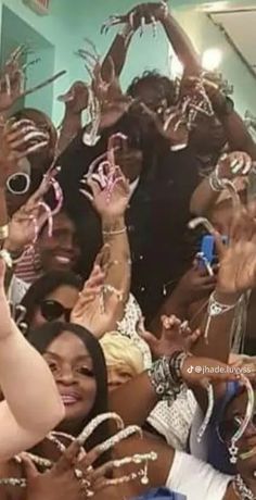 a group of people holding up their hands in the air with rings on each hand