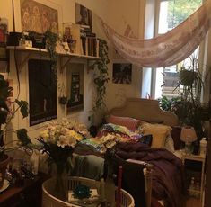 a living room filled with furniture and lots of plants