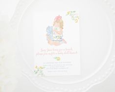 a white plate with a card on it that says, baby's first birthday