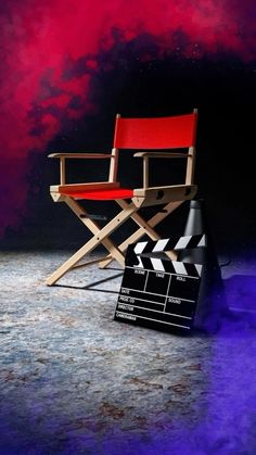 a director's chair sitting in front of a movie clapper on the floor