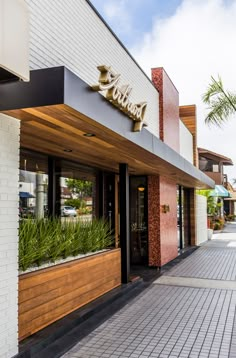 the outside of a restaurant with plants growing out of it