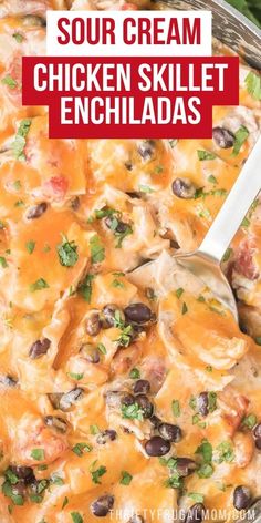 a casserole dish with chicken, black beans and cheese in it that is topped with sour cream