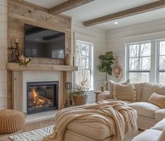 a living room filled with furniture and a flat screen tv mounted on the wall above a fire place