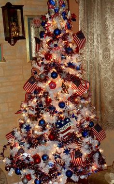 a decorated christmas tree with red, white and blue ornaments in the shape of american flags