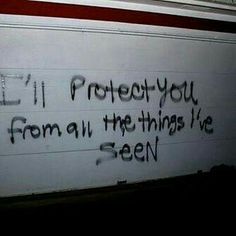 graffiti on the side of a garage door that says i'll protect you from all the things i've seen