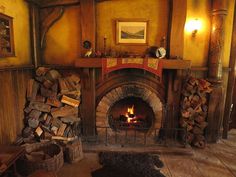 a fireplace with logs stacked on top of it and a fire place in the middle