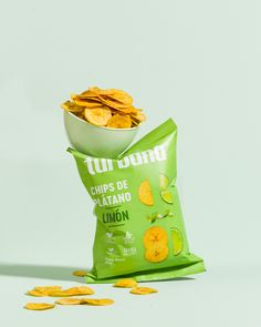 a bag of chips sitting on top of a table next to a pile of lemon slices