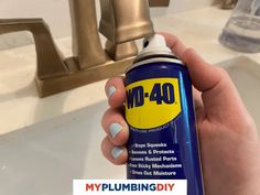 a person holding a spray can in front of a faucet with the words dm - 40 on it